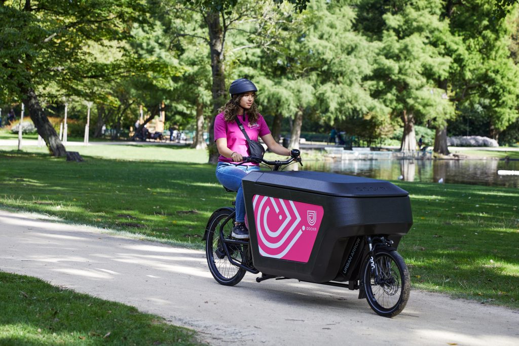 girl on delivery bike in the park